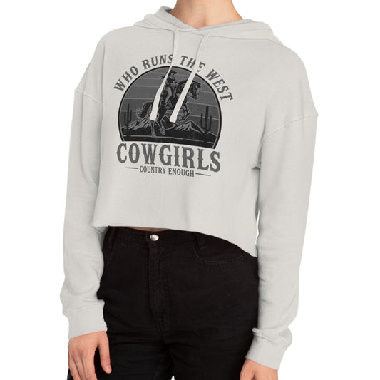 Bone crop hoodie with graphic of a cowgirls on a bucking horse, cacti, mountains, and the words who runs the west cowgirls #bone