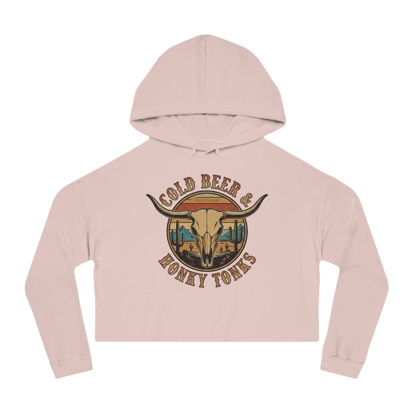 Pale Pink crop hoodie with graphic of longhorn, cacti, and mountains over a retro background with words cold beer and honky tonks #palepink