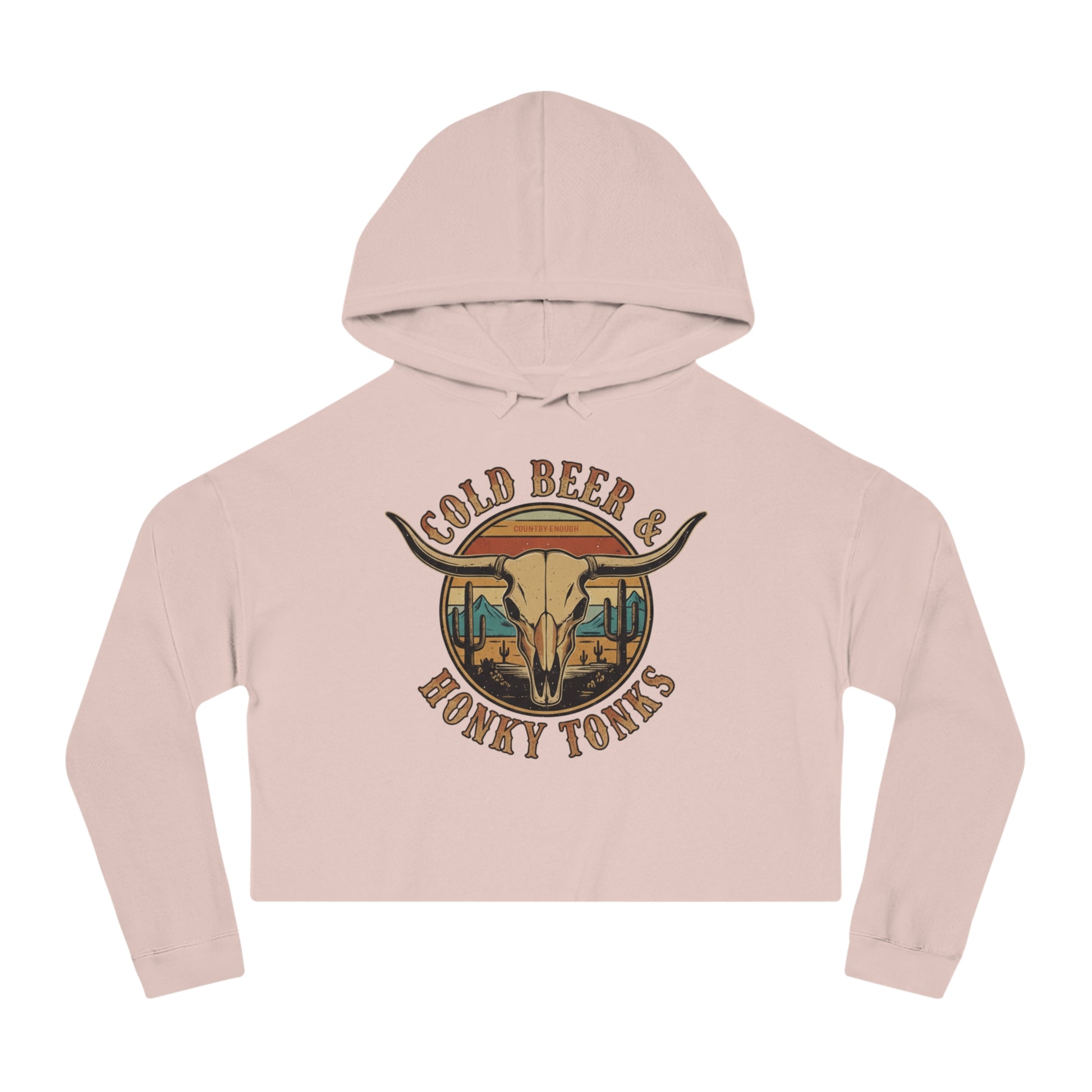 Pale Pink crop hoodie with graphic of longhorn, cacti, and mountains over a retro background with words cold beer and honky tonks #palepink