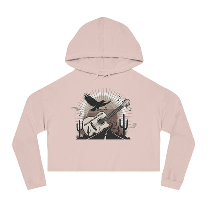 Pale Pink crop hoodie with a graphic of a guitar, a soaring desert bird, cactus silhouettes, and a sunset over a winding road #palepink