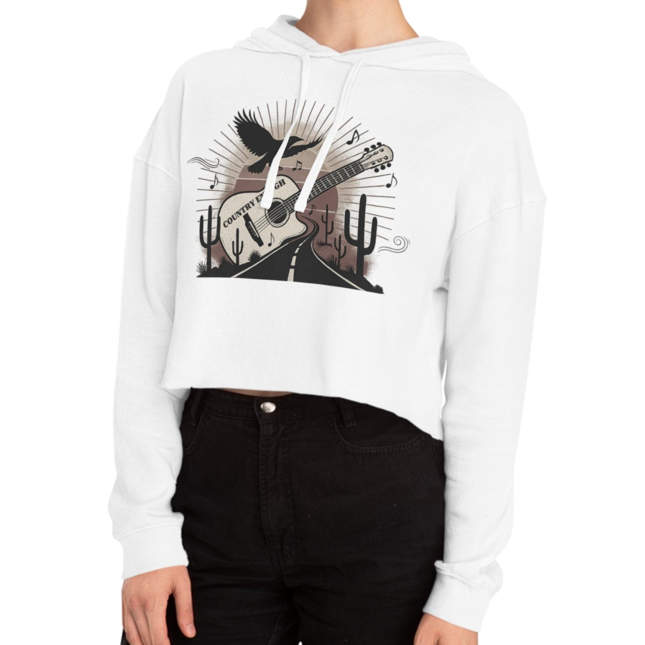 White crop hoodie with a graphic of a guitar, a soaring desert bird, cactus silhouettes, and a sunset over a winding road #white
