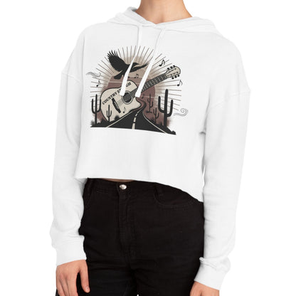 White crop hoodie with a graphic of a guitar, a soaring desert bird, cactus silhouettes, and a sunset over a winding road #white