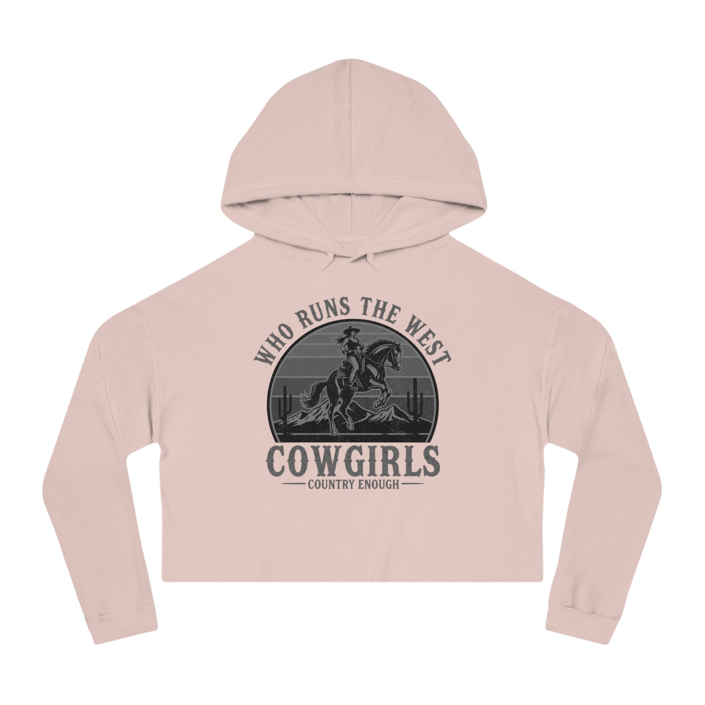 Pale Pink crop hoodie with graphic of a cowgirls on a bucking horse, cacti, mountains, and the words who runs the west cowgirls #palepink