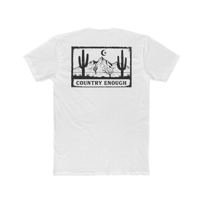 White t-shirt with graphic of mountains, cacti, and moon and star over a desert landscape with words country enough #white
