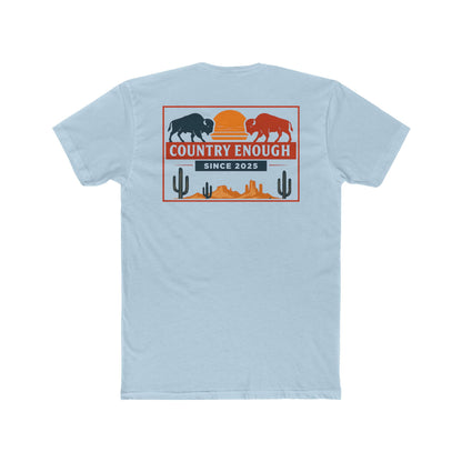Light Blue t-shirt with graphic of mirrored bison in red and blue, sun, desert landscape, cacti, and the words country enough since 2025 #lightblue