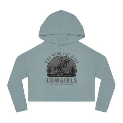 Mineral crop hoodie with graphic of a cowgirls on a bucking horse, cacti, mountains, and the words who runs the west cowgirls #mineral