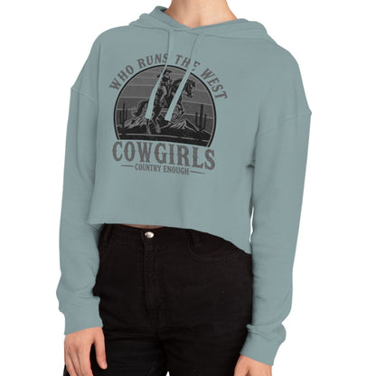 Mineral crop hoodie with graphic of a cowgirls on a bucking horse, cacti, mountains, and the words who runs the west cowgirls #mineral