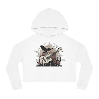 White crop hoodie with a graphic of a guitar, a soaring desert bird, cactus silhouettes, and a sunset over a winding road #white