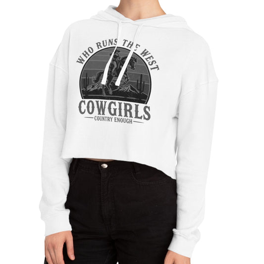 White crop hoodie with graphic of a cowgirls on a bucking horse, cacti, mountains, and the words who runs the west cowgirls #white