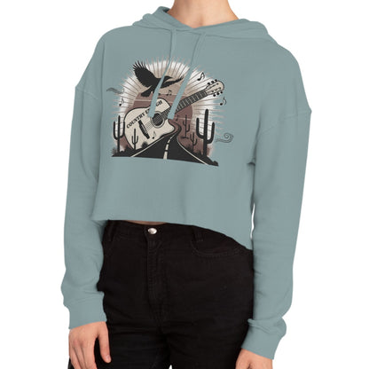 Mineral crop hoodie with a graphic of a guitar, a soaring desert bird, cactus silhouettes, and a sunset over a winding road #mineral