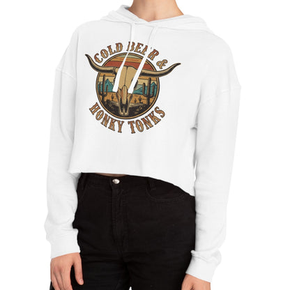 White crop hoodie with graphic of longhorn, cacti, and mountains over a retro background with words cold beer and honky tonks #white