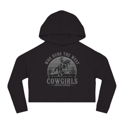 Black crop hoodie with graphic of a cowgirls on a bucking horse, cacti, mountains, and the words who runs the west cowgirls #black