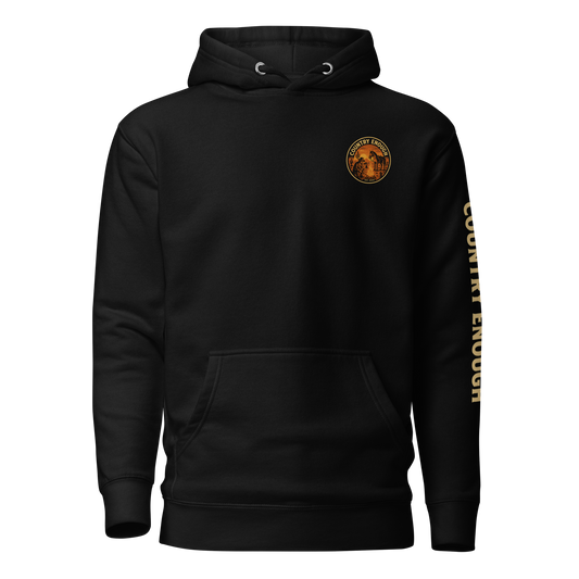 Black hoodie with circular graphic of a cowboy, horse, campfire, sun, cacti and desert landscape with words country enough #black