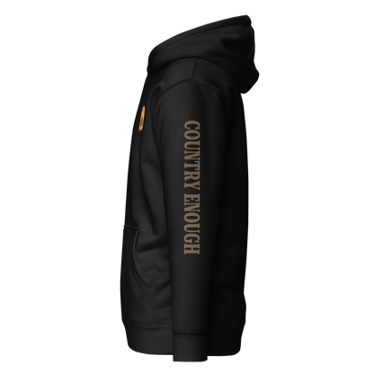 Black hoodie with a chest logo that includes a based, sunset, mountains, and the words country enough #black