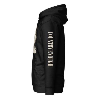 Black hoodie with graphic of a cowgirl silhouette in a light pink color with words country enough #black