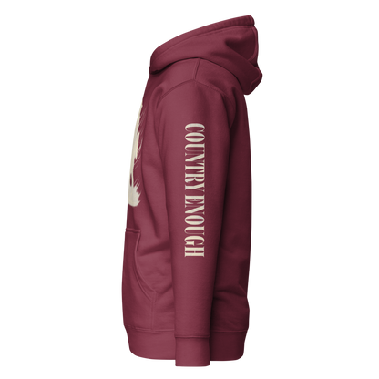 Maroon hoodie with graphic of a cowgirl silhouette in a light pink color with words country enough #maroon