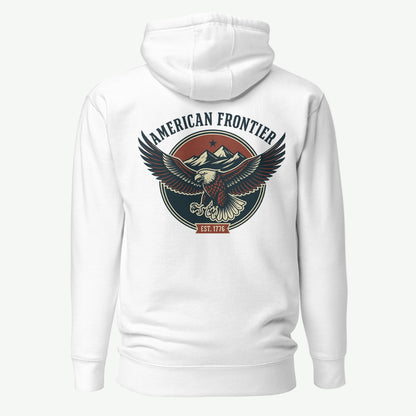 White hoodie with an eagle and mountains in red, white, and blue with words American Frontier EST 1776 #white