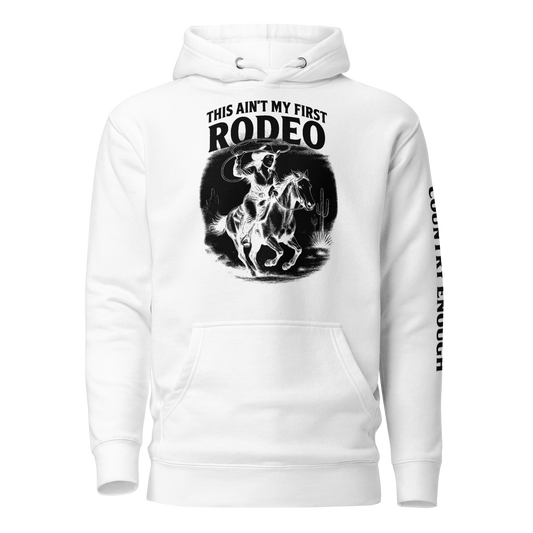 White hoodie with graphic of cowgirl and horse, western landscape, and words this ain't my first rodeo #white