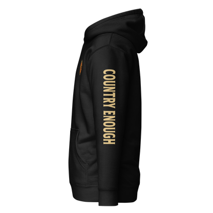 Black hoodie with circular graphic of a cowboy, horse, campfire, sun, cacti and desert landscape with words country enough #black