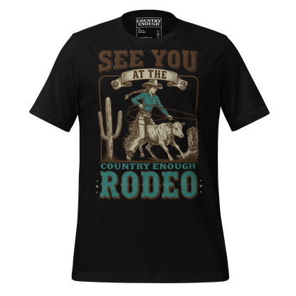 Black t-shirt with graphic of cowgirl, calf, cactus, cowboy boot, and words see you at the rodeo #black