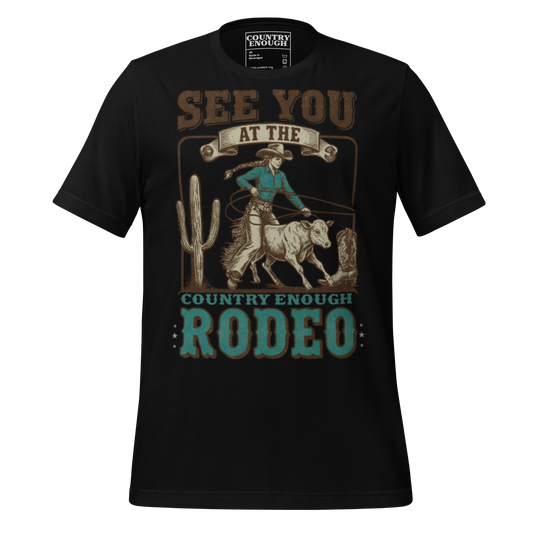 Black t-shirt with graphic of cowgirl, calf, cactus, cowboy boot, and words see you at the rodeo #black