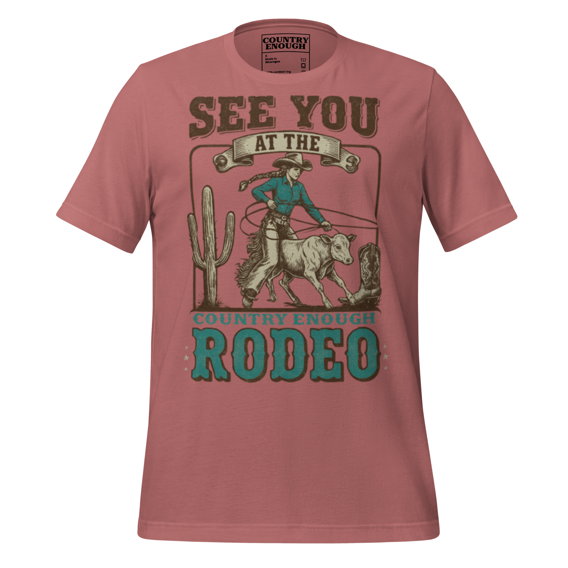 Mauve t-shirt with graphic of cowgirl, calf, cactus, cowboy boot, and words see you at the rodeo #mauve