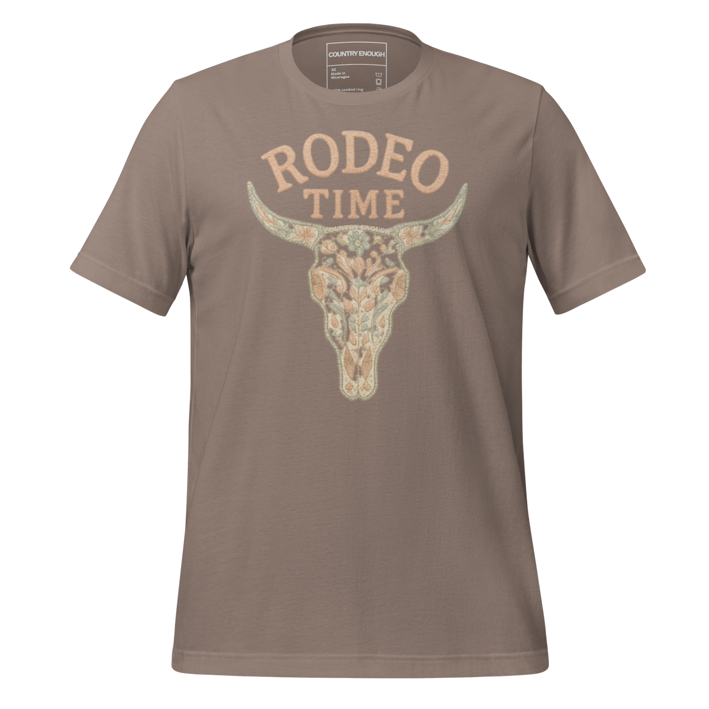 Pebble t-shirt with graphic of a bull skull filled with flower pattern and the words rodeo time above #pebble