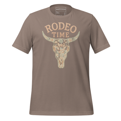 Pebble t-shirt with graphic of a bull skull filled with flower pattern and the words rodeo time above #pebble