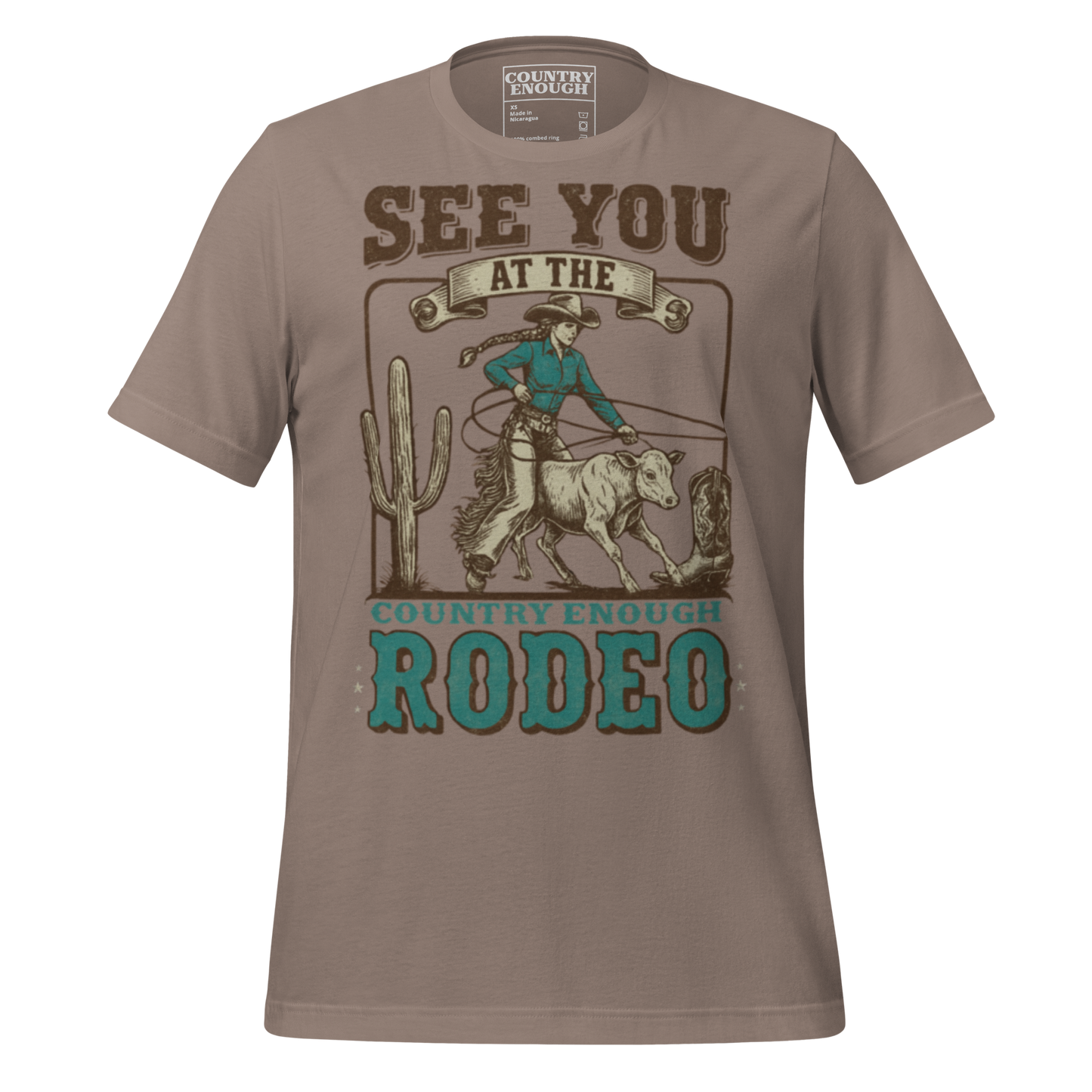 Pebble t-shirt with graphic of cowgirl, calf, cactus, cowboy boot, and words see you at the rodeo #pebble