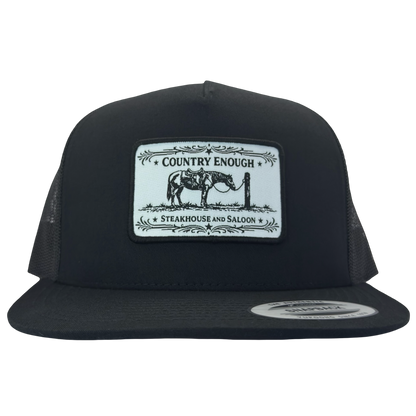 Yupoong 6006 flat bill snapback with a patch that contains a graphic of a horse and says the words country enough steakhouse and saloon #black