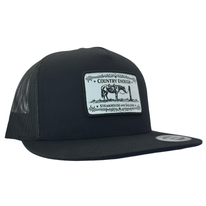 Yupoong 6006 flat bill snapback with a patch that contains a graphic of a horse and says the words country enough steakhouse and saloon #black