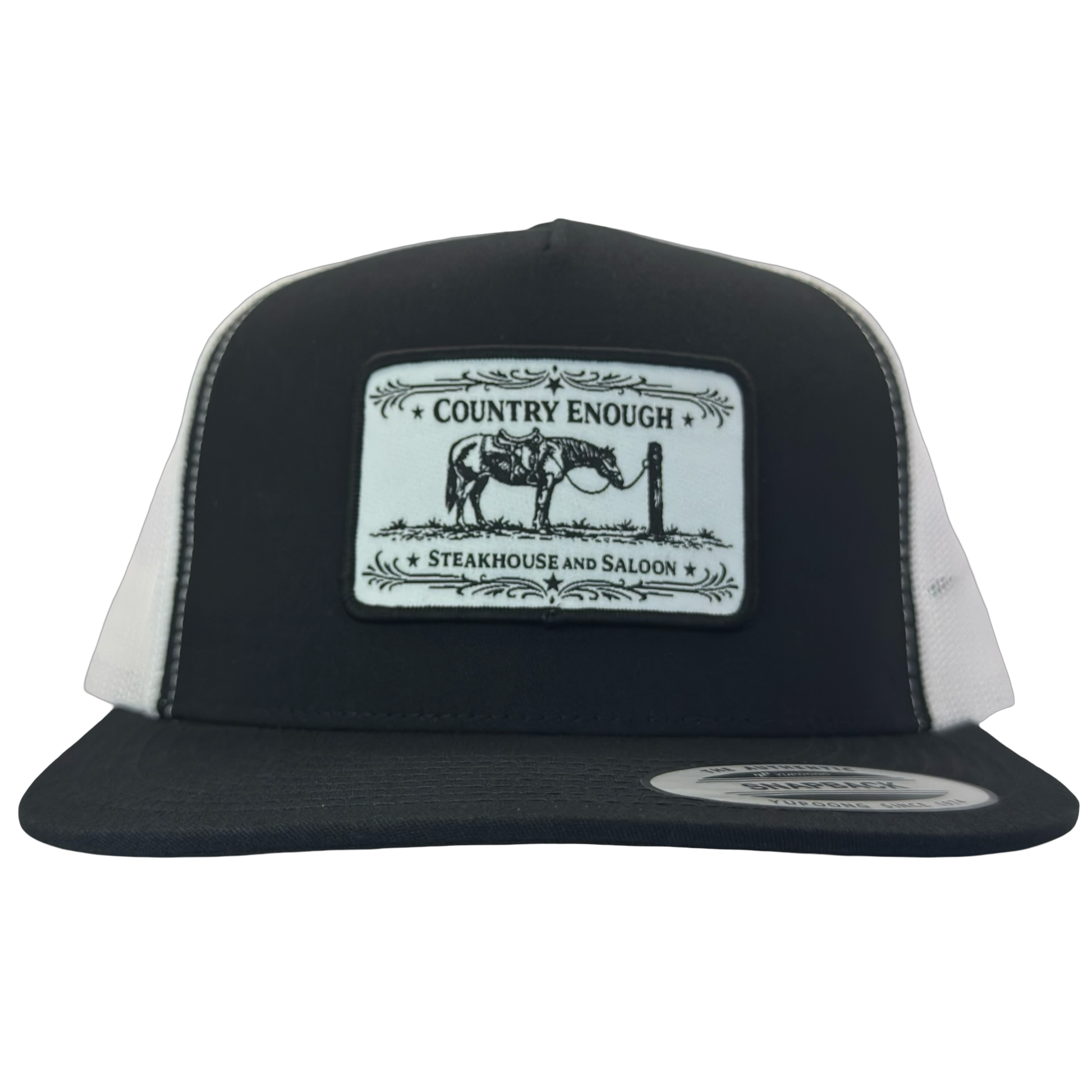 Yupoong 6006 flat bill snapback with a patch that contains a graphic of a horse and says the words country enough steakhouse and saloon #black/white