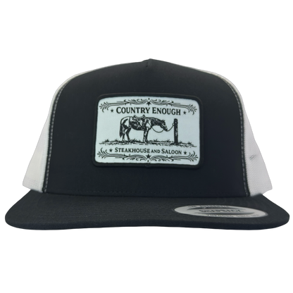 Yupoong 6006 flat bill snapback with a patch that contains a graphic of a horse and says the words country enough steakhouse and saloon #black/white
