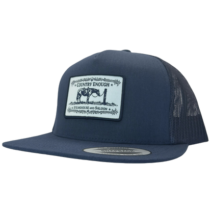 Yupoong 6006 flat bill snapback with a patch that contains a graphic of a horse and says the words country enough steakhouse and saloon #navy