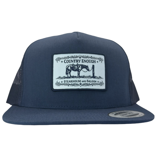 Yupoong 6006 flat bill snapback with a patch that contains a graphic of a horse and says the words country enough steakhouse and saloon #navy