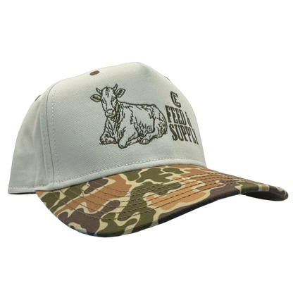 Legacy Heritage HTA snapback with graphic of a cow and the words feed & supply with CE logo #duckcamo