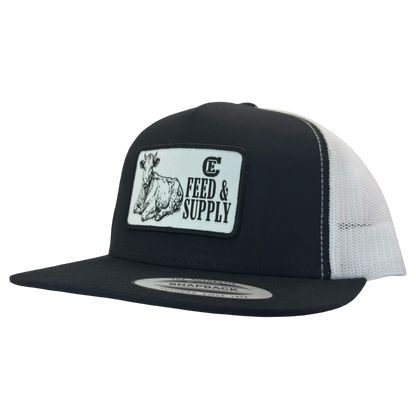 Yupoong 6006 snapback hat with patch that contains graphic of a sitting cow, the words Feed & Supply, and the CE logo. #black/white