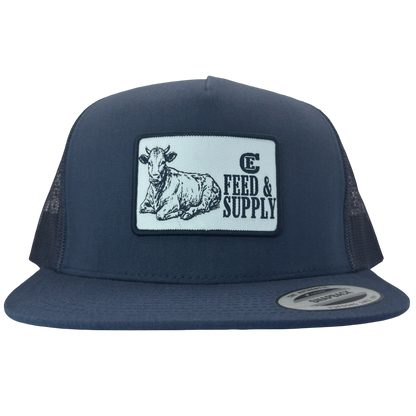Yupoong 6006 snapback hat with patch that contains graphic of a sitting cow, the words Feed & Supply, and the CE logo. #navy