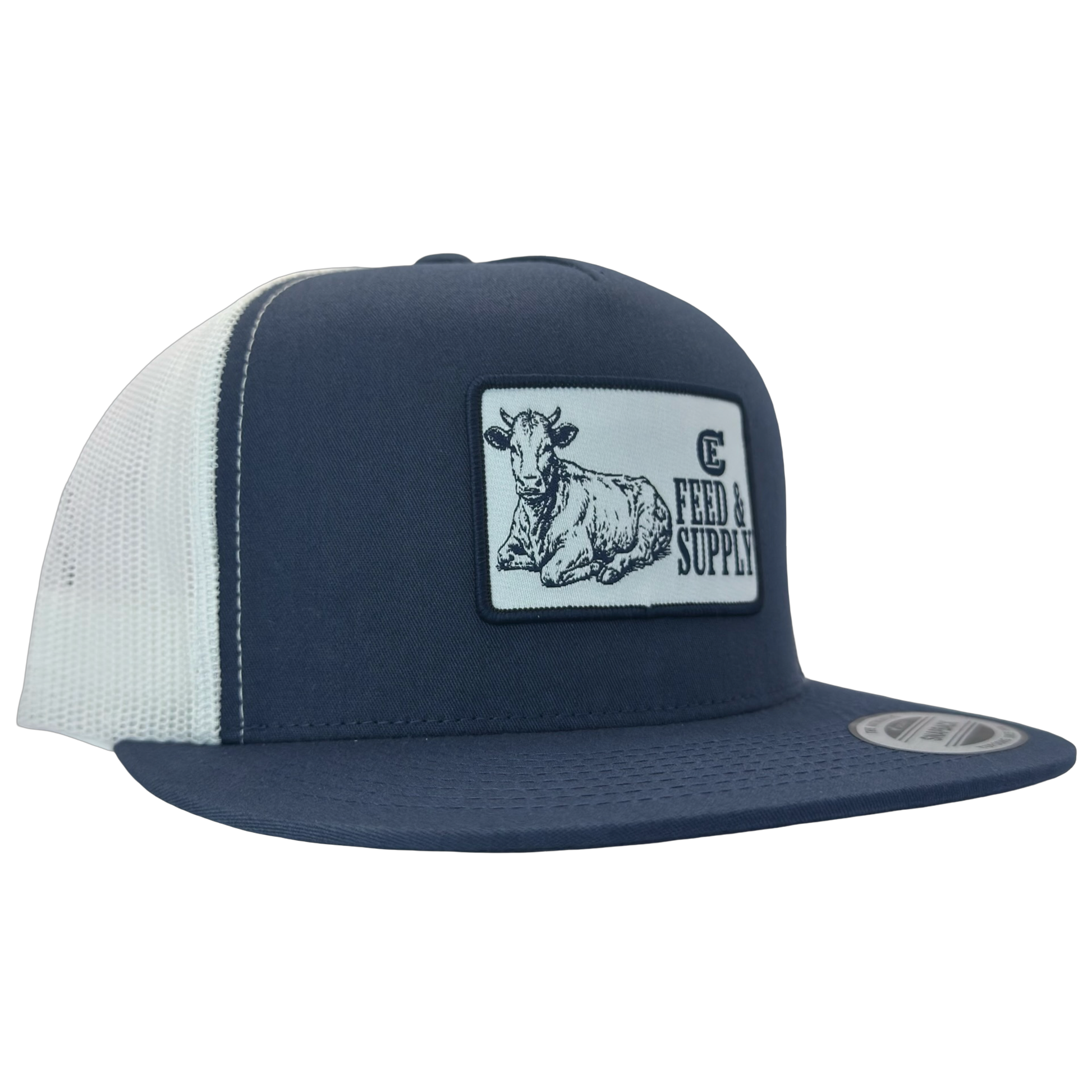 Yupoong 6006 snapback hat with patch that contains graphic of a sitting cow, the words Feed & Supply, and the CE logo. #navy/white
