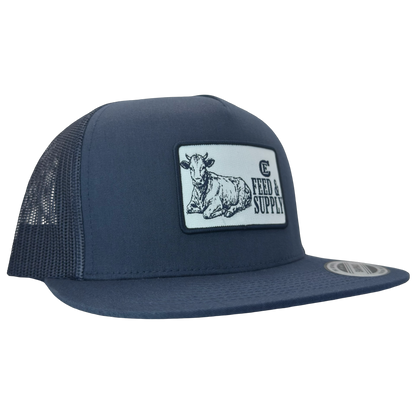 Yupoong 6006 snapback hat with patch that contains graphic of a sitting cow, the words Feed & Supply, and the CE logo. #navy