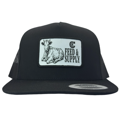 Yupoong 6006 snapback hat with patch that contains graphic of a sitting cow, the words Feed & Supply, and the CE logo. #black