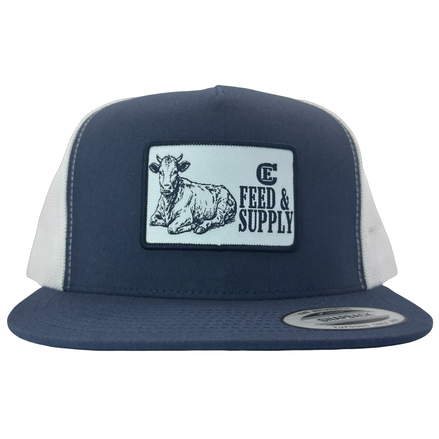 Yupoong 6006 snapback hat with patch that contains graphic of a sitting cow, the words Feed & Supply, and the CE logo. #navy/white