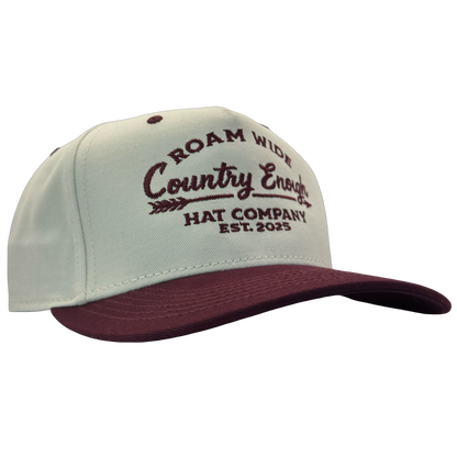 legacy heritage snapback with graphic of arrow and words roam wide, country enough hat company est. 2025 #wine