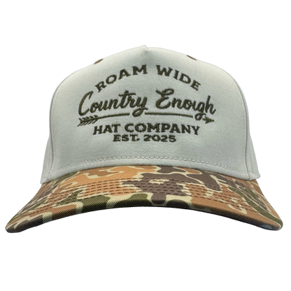 legacy heritage snapback with graphic of arrow and words roam wide, country enough hat company est. 2025 #duckcamo