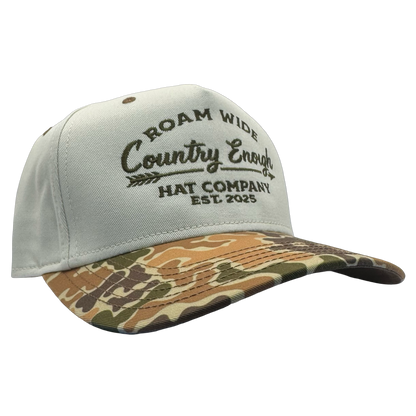 legacy heritage snapback with graphic of arrow and words roam wide, country enough hat company est. 2025 #duckcamo