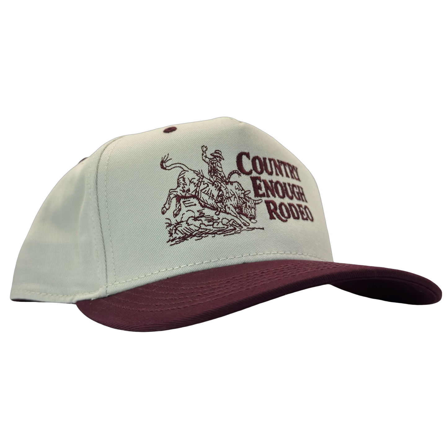 Legacy heritage snapback hat with graphic of bull rider on a bucking bull and the words country enough rodeo #wine
