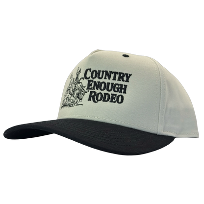Legacy heritage snapback hat with graphic of bull rider on a bucking bull and the words country enough rodeo #black