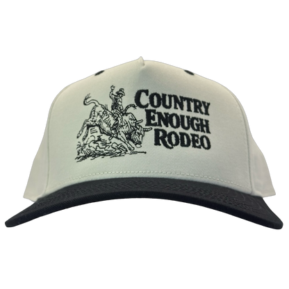 Legacy heritage snapback hat with graphic of bull rider on a bucking bull and the words country enough rodeo #black