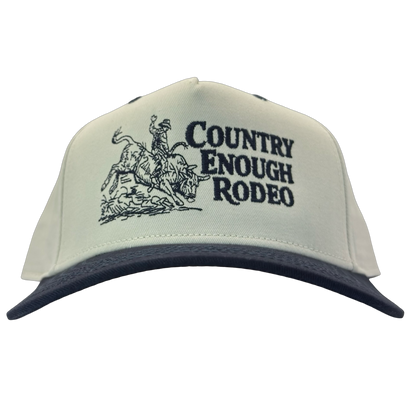 Legacy heritage snapback hat with graphic of bull rider on a bucking bull and the words country enough rodeo #navy