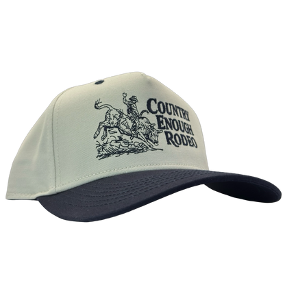 Legacy heritage snapback hat with graphic of bull rider on a bucking bull and the words country enough rodeo #navy